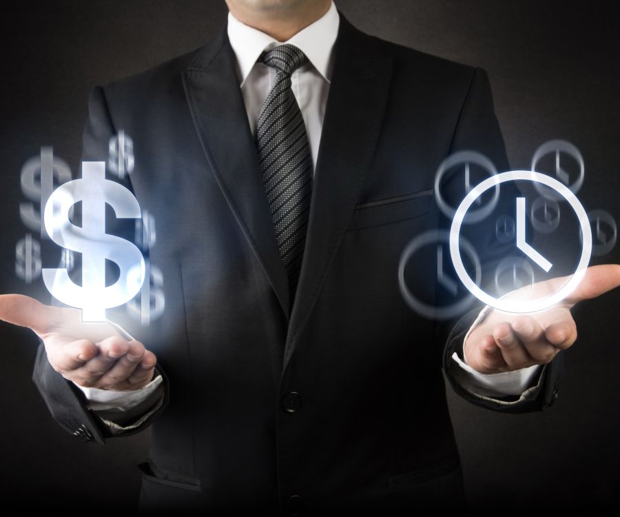 Man in dark suit standing with palms held out. Hovering over each hand is a hologram of a dollar sign  and a clock respectively